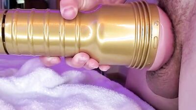 A man masturbates with a vagina dildo until he cums