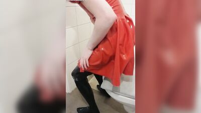 Dressing in red latex hooded swing dress and black rubber stockings