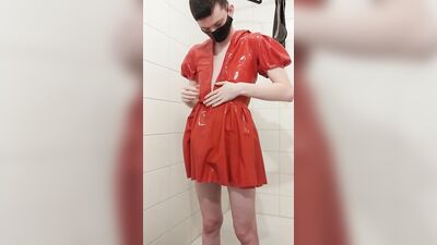 Dressing in red latex hooded swing dress and black rubber stockings