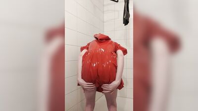 Dressing in red latex hooded swing dress and black rubber stockings