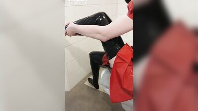 Dressing in red latex hooded swing dress and black rubber stockings