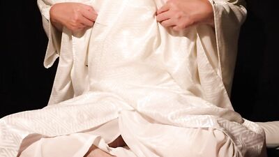 Dressed in a white robe, leaking white fluid.