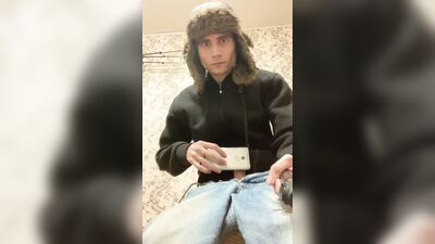 A guy in a jacket and a hat masturbates and cums upside down on his jacket