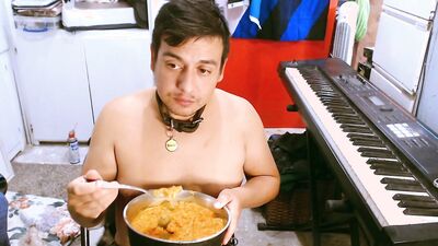 M a x x eats from a dog bowl in a dog collar