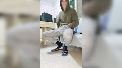 Huge jock in flip flops jacking off on a sofa