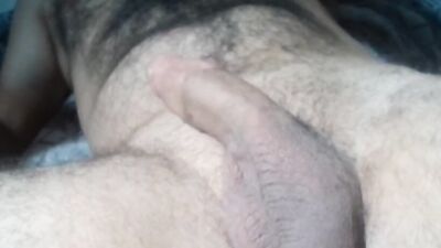 Solo male jerking off hard his circumcised big dick and touching his hairy chest with hot moanings