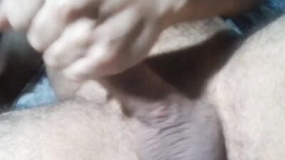 Solo male jerking off hard his circumcised big dick and touching his hairy chest with hot moanings
