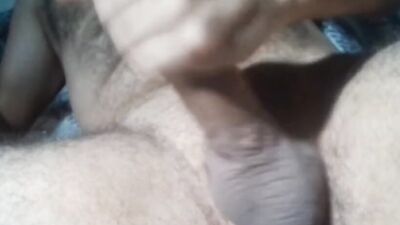Solo male jerking off hard his circumcised big dick and touching his hairy chest with hot moanings