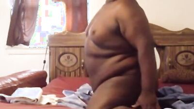 Fat black dude is shoving a dildo deep down his ass