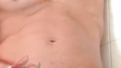 Good looking beefed dude strokes his prick under the shower