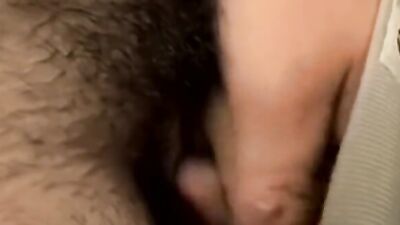 Long haired dude is jerking his pecker in front of the camera