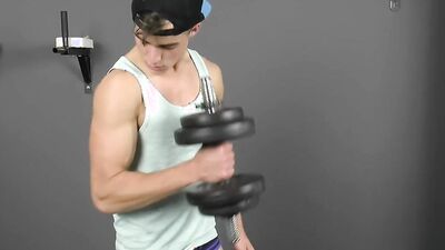 Handsome straight lad is flexing in front of the camera