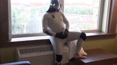 showing off wetsuits at hotel window