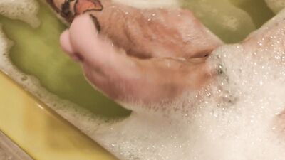 Amputee man bathes alone without hands and masturbates his big cock with his foot and stump