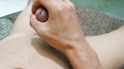 Hand rubbing cock out of sperm in the stomach