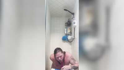 Chubby white guy Neil sucks and fucks dildo in the shower