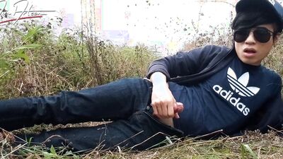 Cute gay Asian twink Jon Arteen speaks French wanks his smooth penis in the rain, lubricated with his saliva moans ejaculates