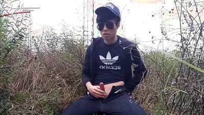 Cute gay Asian twink Jon Arteen speaks French wanks his smooth penis in the rain, lubricated with his saliva moans ejaculates