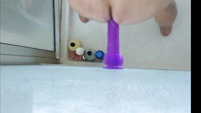Dildo ass fucking in the shower