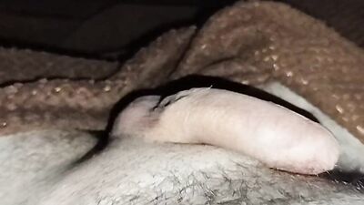 Close-up handjob in a thin condom with cumming in it.