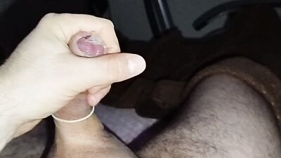 Close-up handjob in a thin condom with cumming in it.