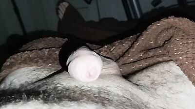Close-up handjob in a thin condom with cumming in it.