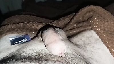 Close-up handjob in a thin condom with cumming in it.
