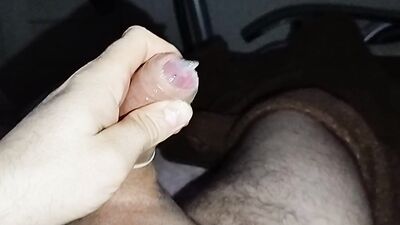 Close-up handjob in a thin condom with cumming in it.