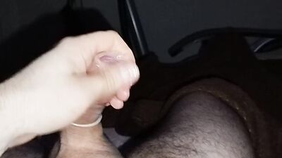 Close-up handjob in a thin condom with cumming in it.
