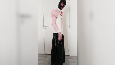 Putting on pink frilly latex blouse over long rubber skirt, maid stockings, transparent panties, layers