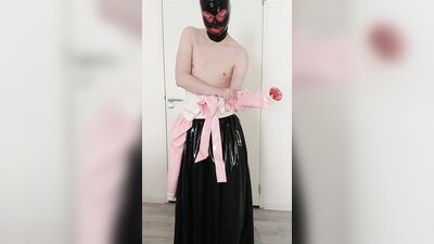Putting on pink frilly latex blouse over long rubber skirt, maid stockings, transparent panties, layers