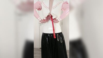 Putting on pink frilly latex blouse over long rubber skirt, maid stockings, transparent panties, layers