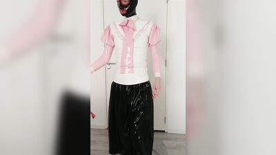 Putting on pink frilly latex blouse over long rubber skirt, maid stockings, transparent panties, layers