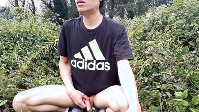 Jon Arteen, a gay Asian twink, is dressed in an Adidas t-shirt, hot pants, white socks, and Duramo sneakers. He jerks off