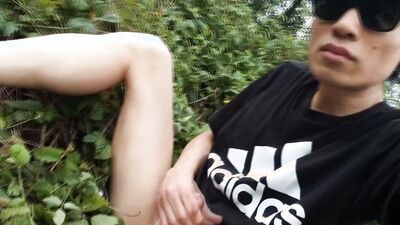 Jon Arteen, a gay Asian twink, is dressed in an Adidas t-shirt, hot pants, white socks, and Duramo sneakers. He jerks off