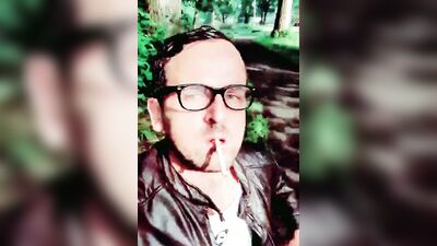 Horny man smokes a cigar and strokes that cock in the woods