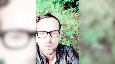 Horny man smokes a cigar and strokes that cock in the woods