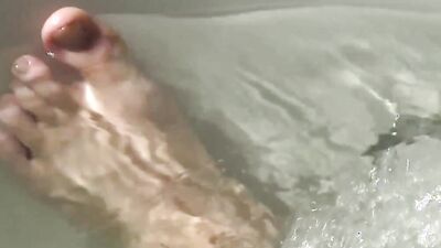 Tattooed fellow is jerking his cock inside the hot tub