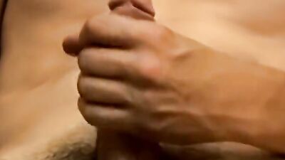 Horny young dude strips and plays with his hard cock solo